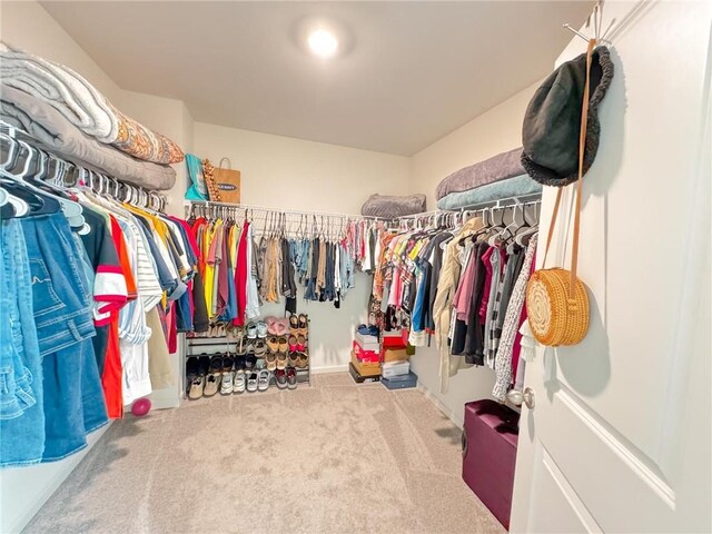 walk in closet with carpet