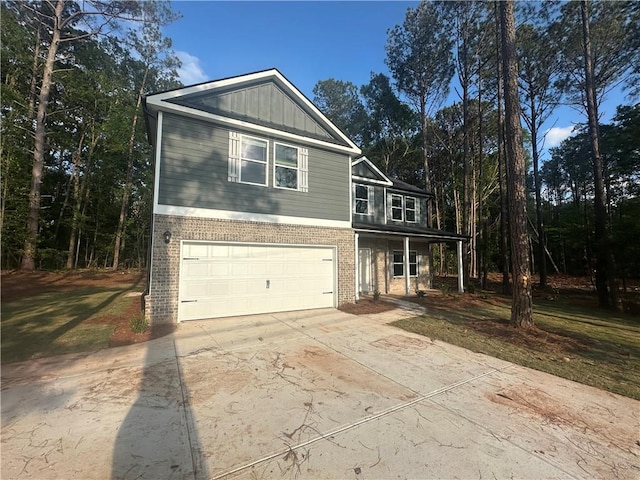 142 Tye St, Stockbridge, GA 30281 - craftsman-style house with brick siding, an attached garage, driveway, covered porch, and board and batten siding