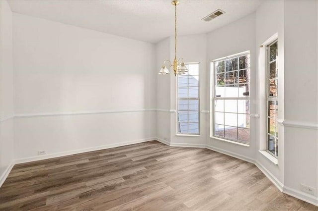 2736 Parkway Trl, Lithonia, GA 30058 - unfurnished dining area featuring wood finished floors, a chandelier, and baseboards
