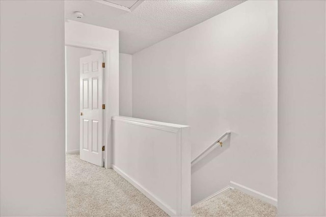 2736 Parkway Trl, Lithonia, GA 30058 - hallway featuring an upstairs landing, a textured ceiling, carpet floors, and baseboards