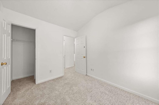 2736 Parkway Trl, Lithonia, GA 30058 - unfurnished bedroom with vaulted ceiling, carpet, baseboards, a closet, and a spacious closet