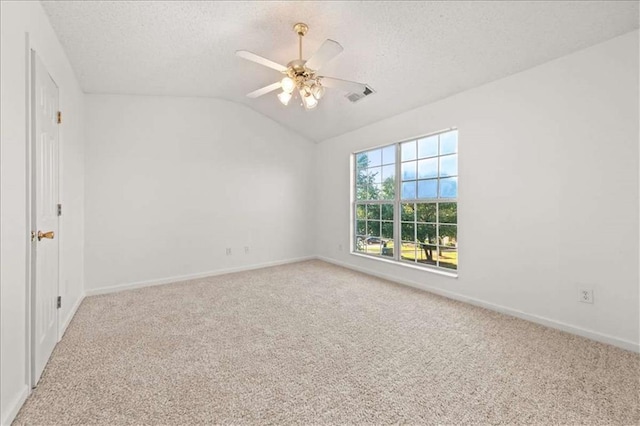 2736 Parkway Trl, Lithonia, GA 30058 - carpeted empty room featuring a textured ceiling, baseboards, a ceiling fan, and vaulted ceiling