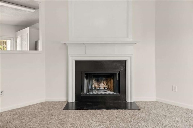 2736 Parkway Trl, Lithonia, GA 30058 - detailed view of carpet flooring, a fireplace with flush hearth, a textured ceiling, and baseboards