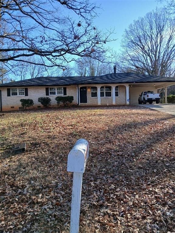 ranch-style home with a carport