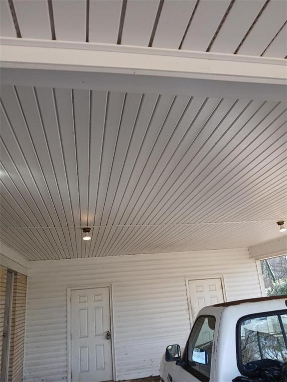 property entrance featuring a carport