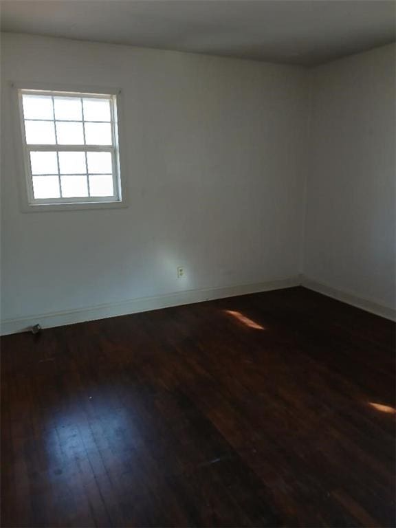 spare room with dark hardwood / wood-style flooring