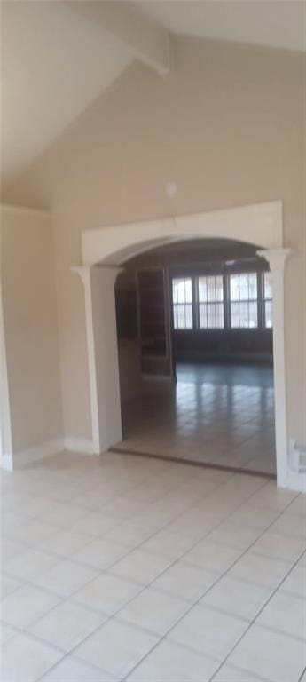 spare room with high vaulted ceiling and beamed ceiling