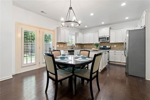 5285 Winflow Way, Suwanee, GA 30024 - dining room featuring a chandelier, dark wood-style floors, recessed lighting, and baseboards