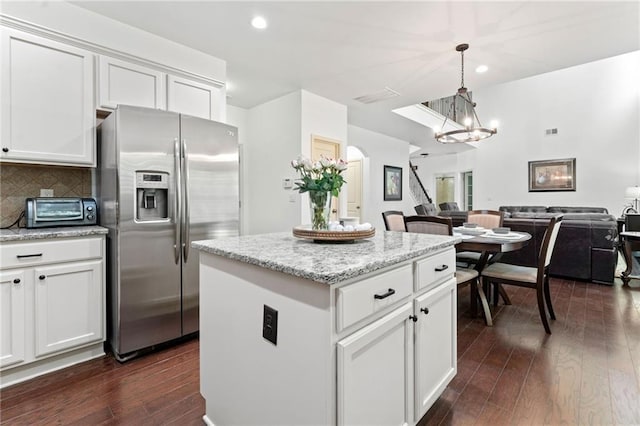 5285 Winflow Way, Suwanee, GA 30024 - kitchen featuring stainless steel fridge, open floor plan, a chandelier, dark wood finished floors, and a center island