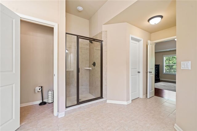 5285 Winflow Way, Suwanee, GA 30024 - bathroom with baseboards, a stall shower, and tile patterned flooring