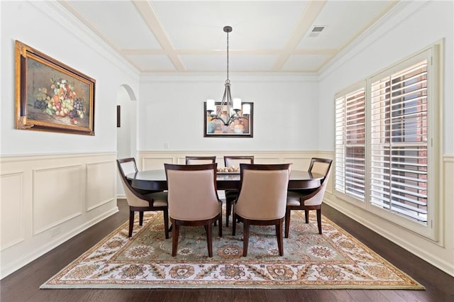 5285 Winflow Way, Suwanee, GA 30024 - dining space with coffered ceiling, a chandelier, dark wood finished floors, arched walkways, and a wainscoted wall