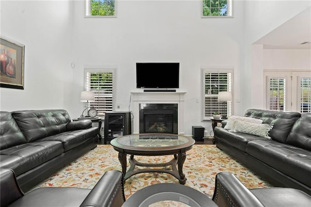 5285 Winflow Way, Suwanee, GA 30024 - living area with a high ceiling and a glass covered fireplace