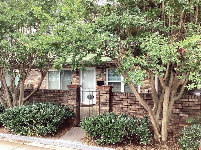 307 Adair St Unit 7-E, Decatur, GA 30030 - obstructed view of property with brick siding and a fenced front yard