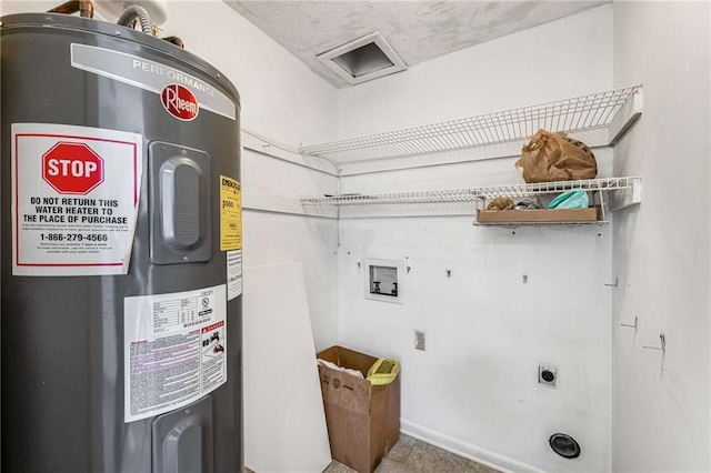 clothes washing area featuring electric water heater, hookup for an electric dryer, and hookup for a washing machine