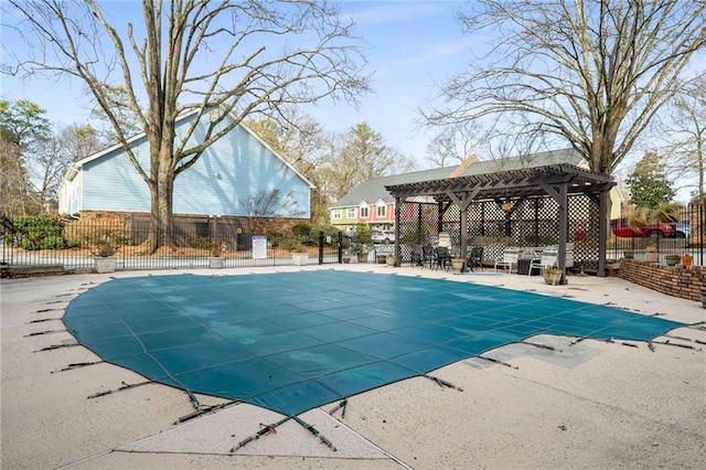 community pool featuring fence and a patio