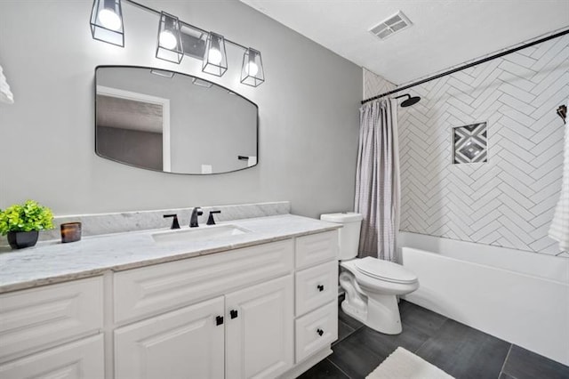 full bathroom featuring tile patterned floors, shower / bath combo with shower curtain, vanity, and toilet