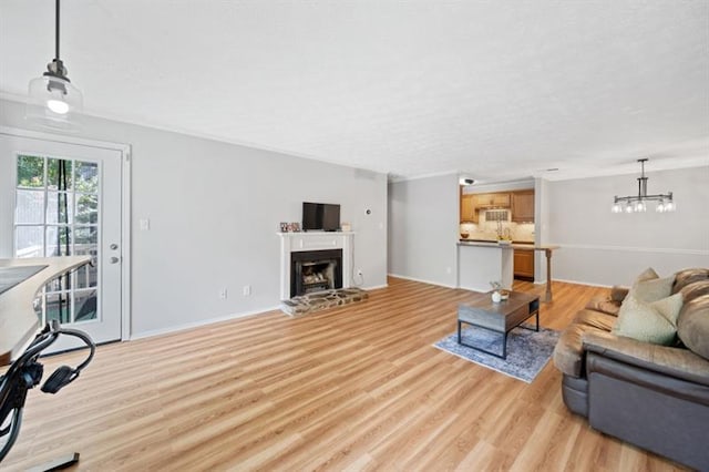 living room with a chandelier and light wood-type flooring