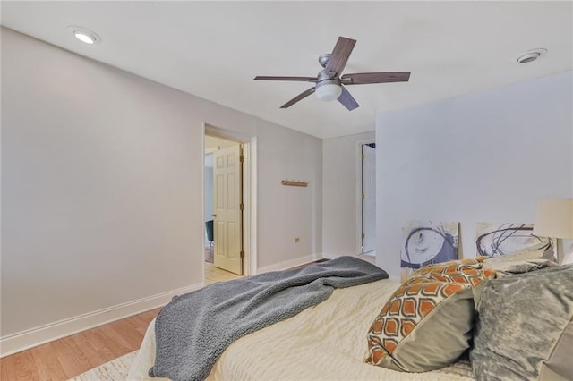 bedroom featuring a ceiling fan, baseboards, and wood finished floors