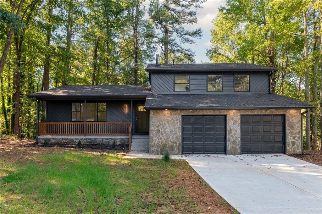 view of front of property featuring covered porch and a garage