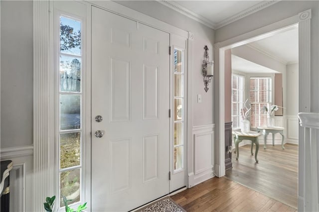 foyer with crown molding and hardwood / wood-style floors