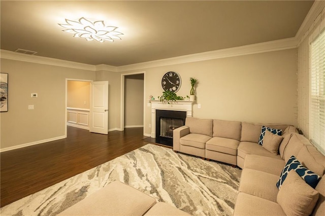 living room featuring dark hardwood / wood-style flooring and ornamental molding