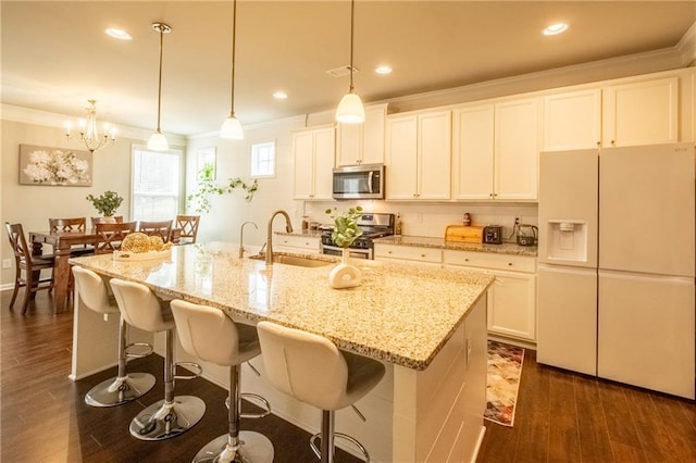 kitchen with pendant lighting, sink, appliances with stainless steel finishes, a kitchen island with sink, and ornamental molding