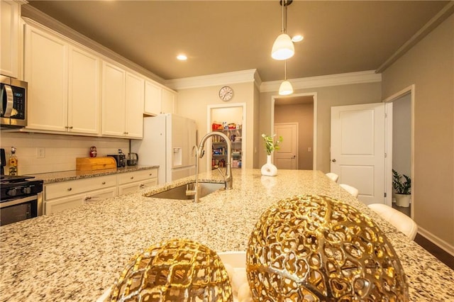 kitchen featuring pendant lighting, sink, crown molding, white cabinetry, and light stone countertops