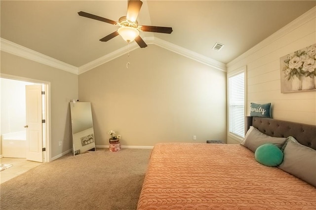 carpeted bedroom with ornamental molding, vaulted ceiling, ensuite bathroom, and ceiling fan