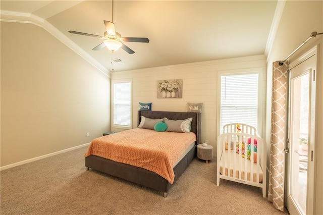 carpeted bedroom featuring crown molding, vaulted ceiling, and ceiling fan