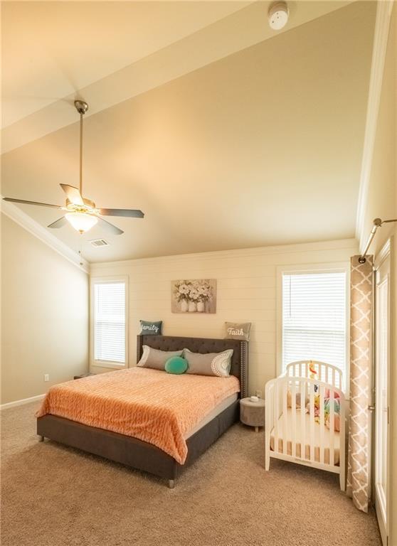 bedroom with ornamental molding, carpet flooring, and ceiling fan