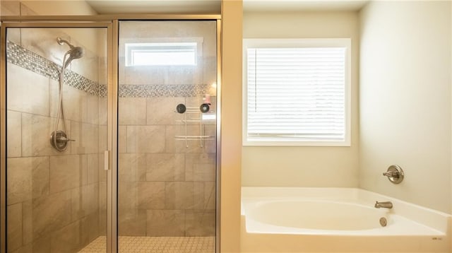 bathroom with separate shower and tub