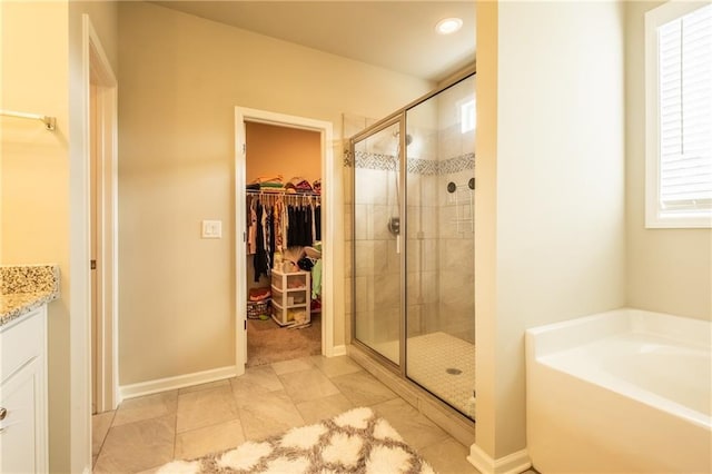 bathroom with vanity and independent shower and bath