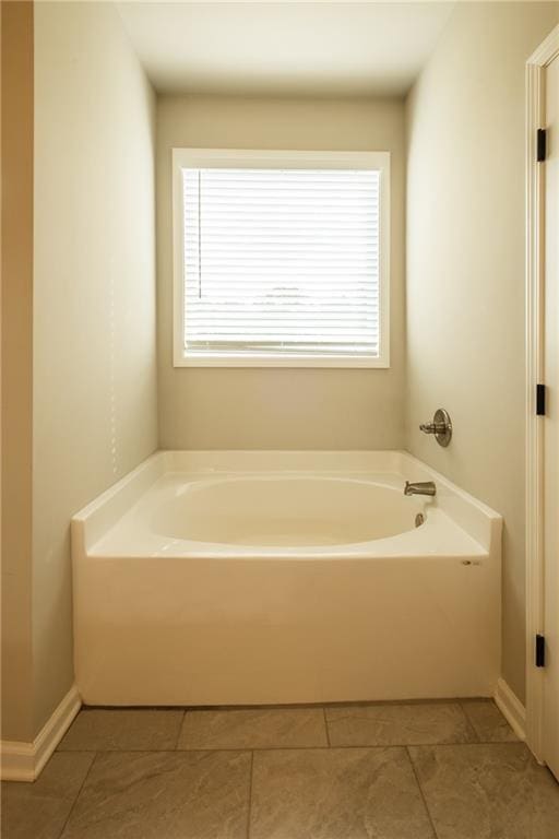 bathroom featuring tile patterned flooring and a tub