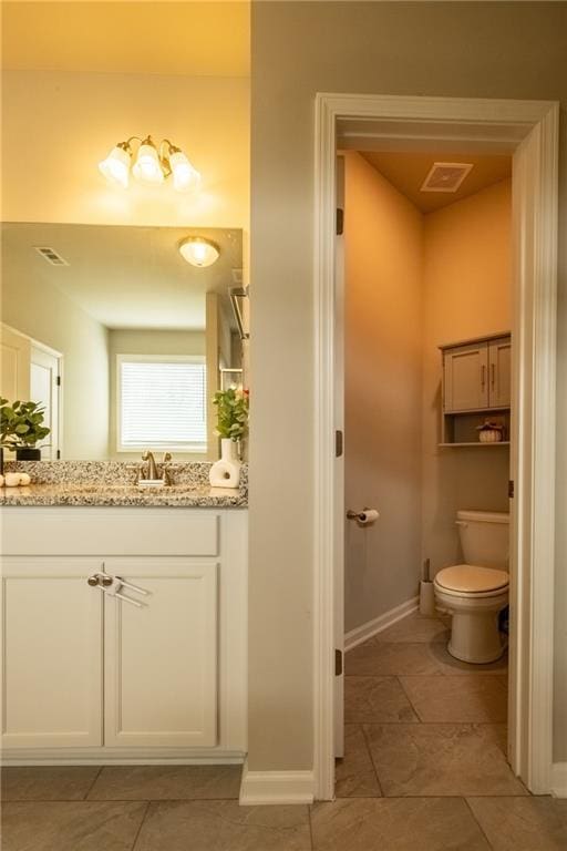 bathroom with vanity and toilet