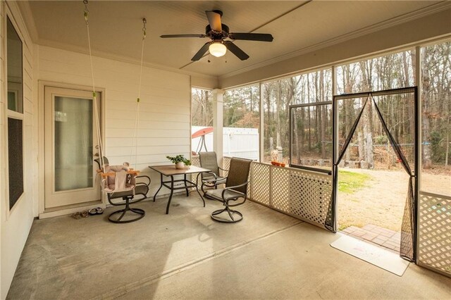 sunroom / solarium featuring plenty of natural light and ceiling fan