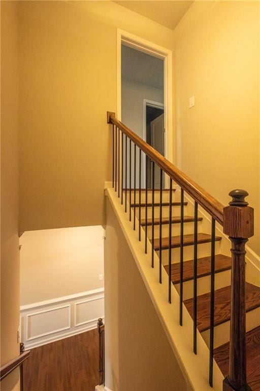 stairs featuring wood-type flooring