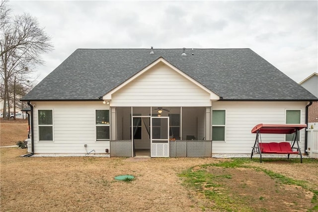 back of property featuring a sunroom, ceiling fan, and a lawn