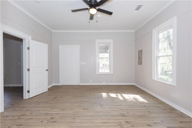 spare room with ornamental molding, light hardwood / wood-style floors, and ceiling fan