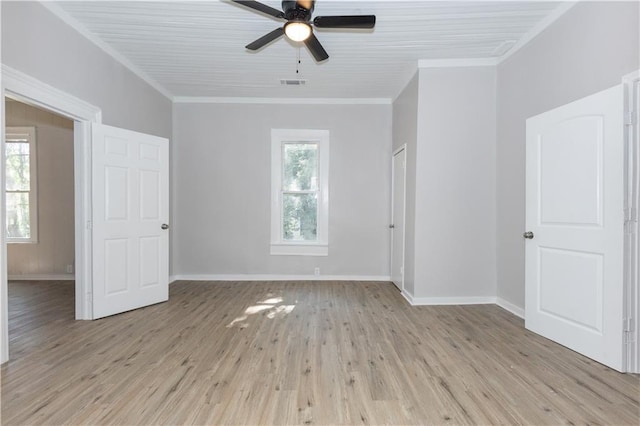 empty room featuring ceiling fan, ornamental molding, and light wood-type flooring