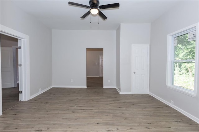 empty room with wood-type flooring and ceiling fan