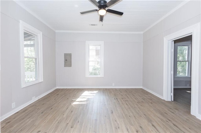 spare room featuring crown molding, light hardwood / wood-style flooring, electric panel, and ceiling fan