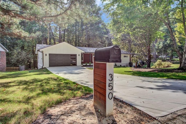 view of front of property with a garage and a front yard