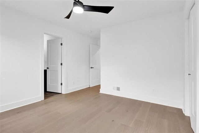 unfurnished bedroom with ceiling fan and light wood-type flooring