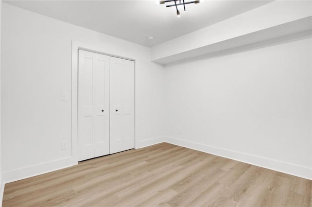 unfurnished bedroom featuring a closet and light hardwood / wood-style flooring