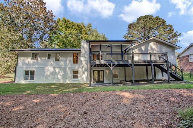 rear view of property with ceiling fan and a deck