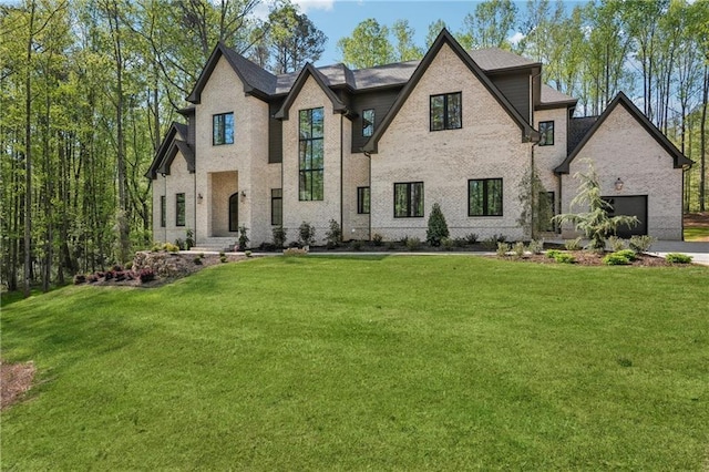 4235 Drew Campground Rd, Alpharetta, GA 30004 - french country home with a front lawn, brick siding, and an attached garage