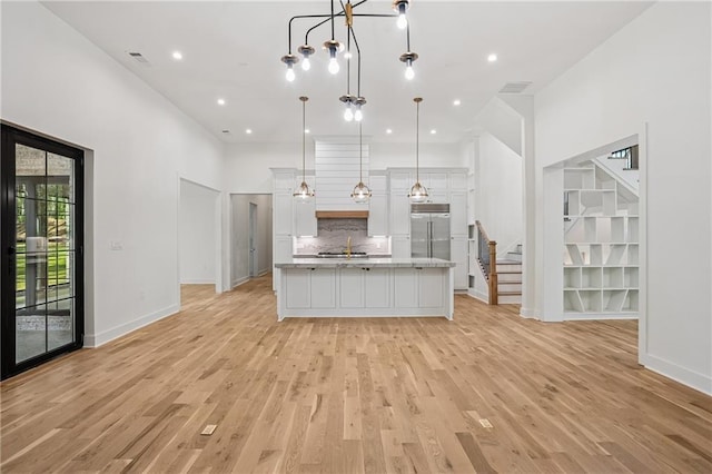 4235 Drew Campground Rd, Alpharetta, GA 30004 - kitchen with a sink, white cabinetry, light wood finished floors, and recessed lighting