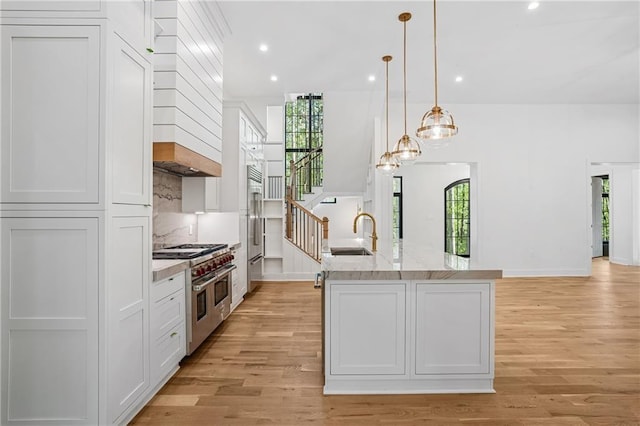 4235 Drew Campground Rd, Alpharetta, GA 30004 - kitchen with premium appliances, a sink, light wood-style flooring, white cabinets, and recessed lighting