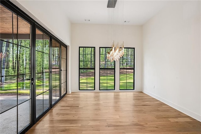 4235 Drew Campground Rd, Alpharetta, GA 30004 - empty room featuring light wood finished floors, a chandelier, and baseboards