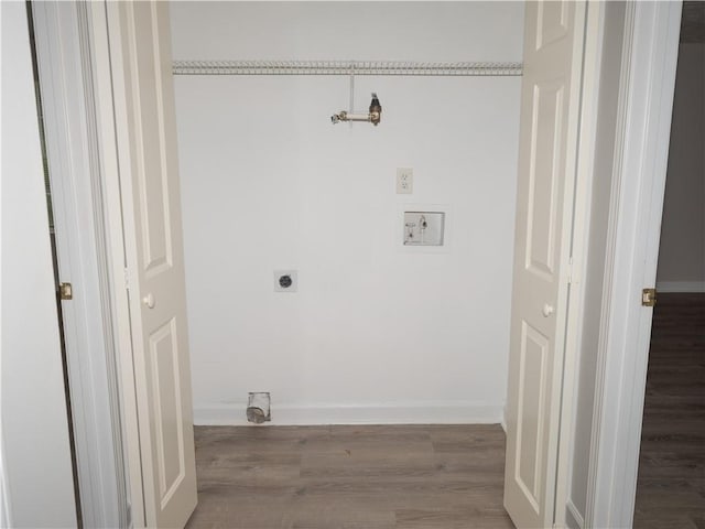 clothes washing area featuring laundry area, hookup for an electric dryer, baseboards, and wood finished floors